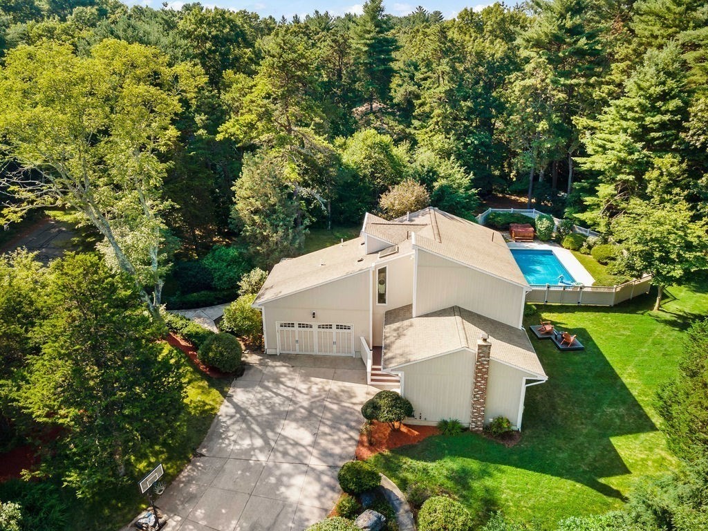 an aerial view of a house with a yard and fountain