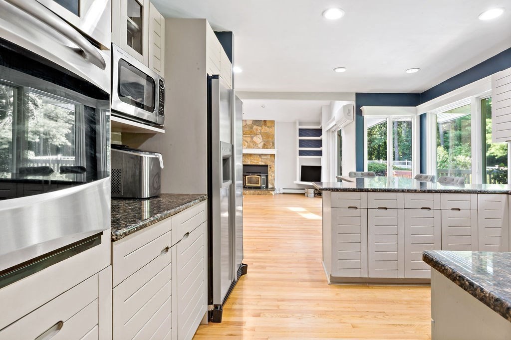 25 Hickory Ridge Road Rehoboth, MA 02769 - Photo 12 of 42 a large kitchen with stainless steel appliances kitchen island granite countertop a large window and a counter top space