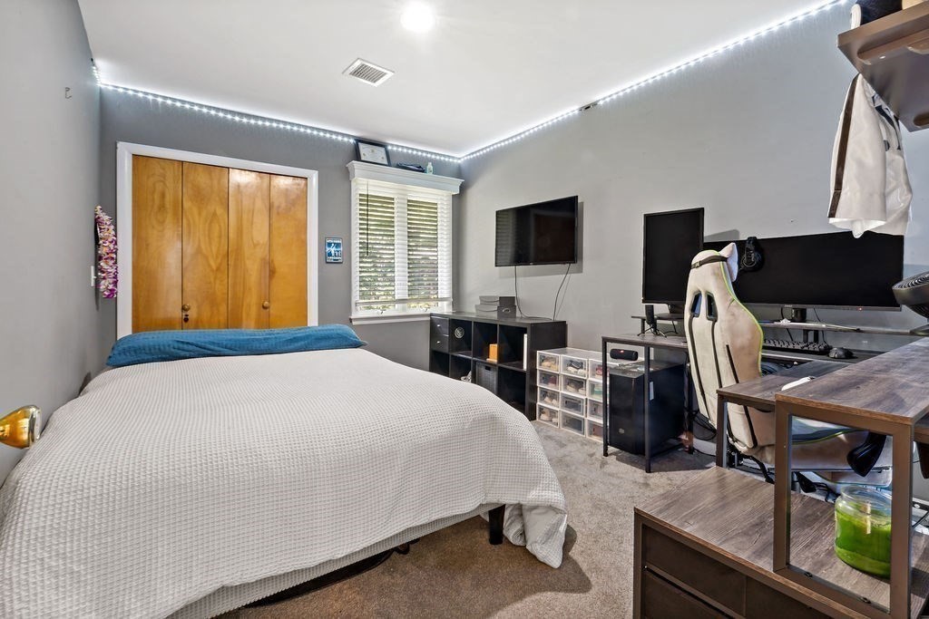 25 Hickory Ridge Road Rehoboth, MA 02769 - Photo 27 of 42 a bedroom with a bed and a flat screen tv