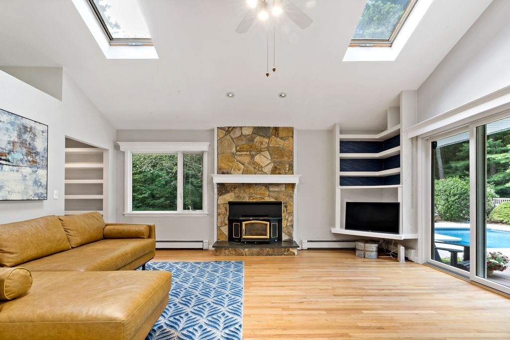 25 Hickory Ridge Road Rehoboth, MA 02769 - Photo 3 of 42 a living room with furniture flat screen tv and a fireplace