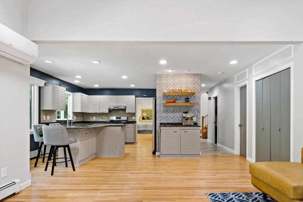 25 Hickory Ridge Road Rehoboth, MA 02769 - Photo 6 of 42 a kitchen with stainless steel appliances kitchen island granite countertop a refrigerator and stove top oven