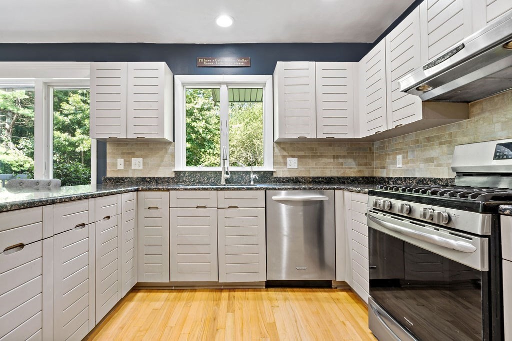25 Hickory Ridge Road Rehoboth, MA 02769 - Photo 9 of 42 a kitchen with stainless steel appliances granite countertop a stove a sink and white cabinets with wooden floor