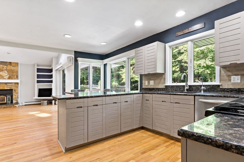 25 Hickory Ridge Road Rehoboth, MA 02769 - Photo 10 of 42 a kitchen with stainless steel appliances granite countertop sink stove and wooden cabinets