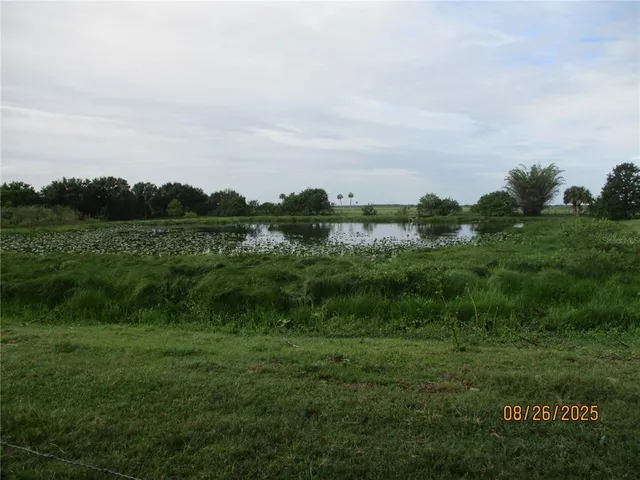 a view of a lake with a house in the background