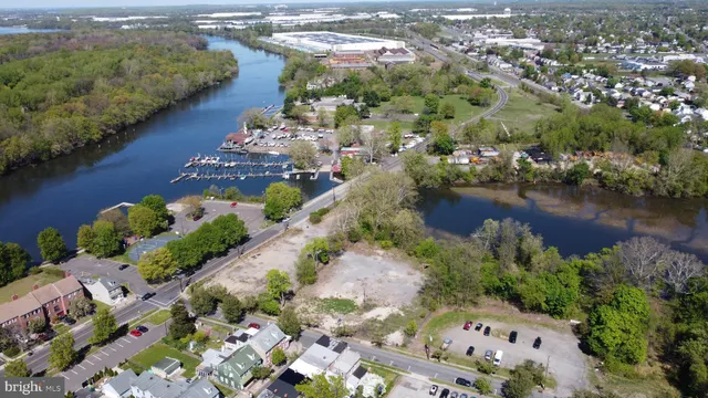 an aerial view of residential houses with outdoor space and lake view