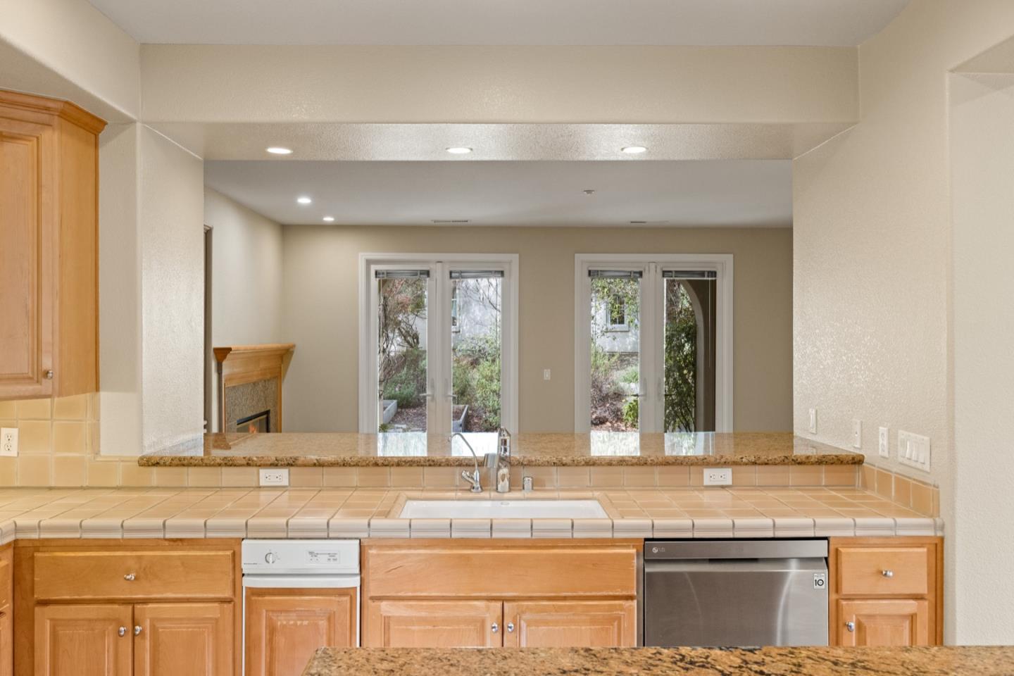 306 Pasadera Drive Monterey, CA 93940 - Photo 21 of 55 a bathroom with granite countertop a sink and a large mirror next to a window