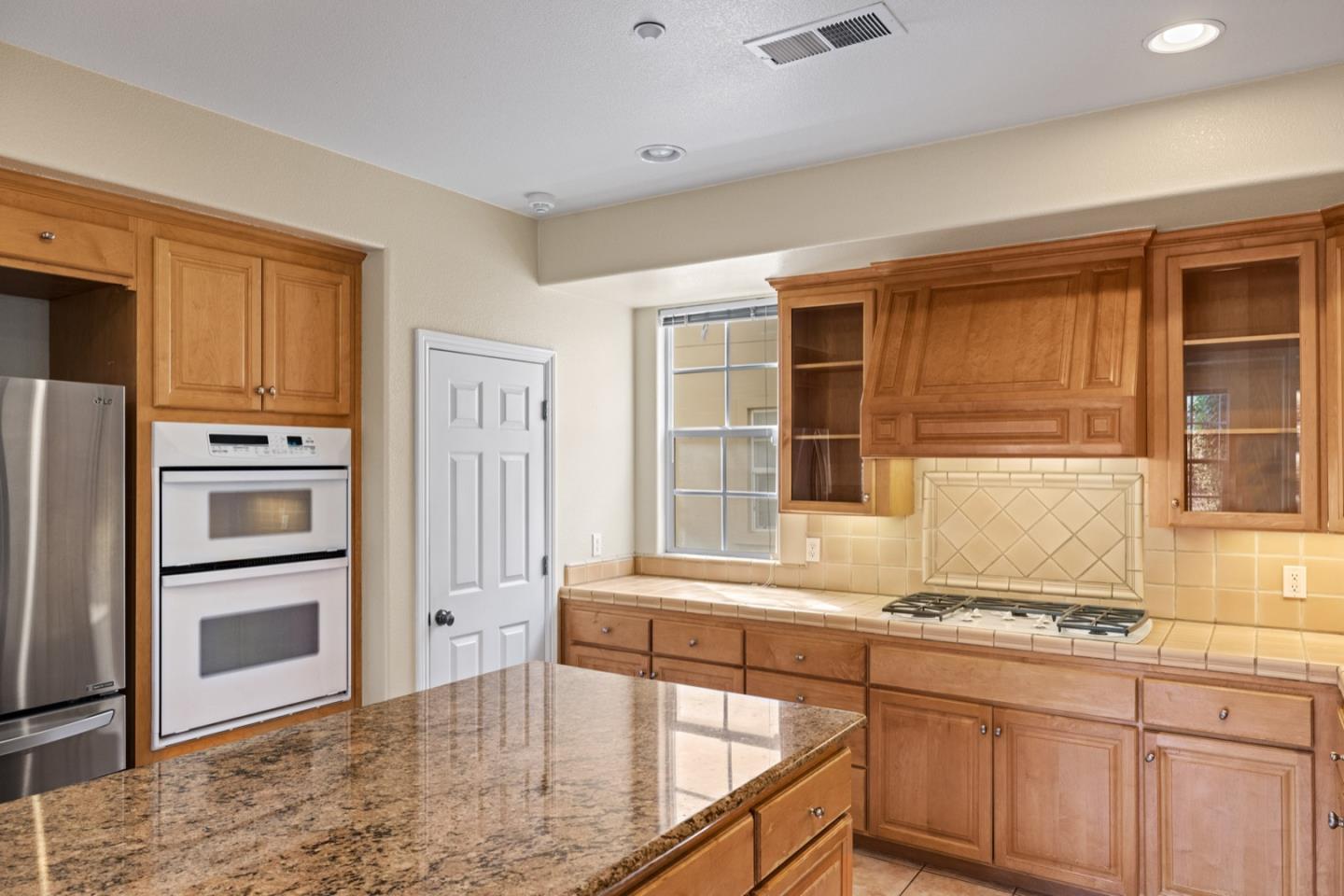 306 Pasadera Drive Monterey, CA 93940 - Photo 22 of 55 a kitchen with granite countertop a sink and a refrigerator