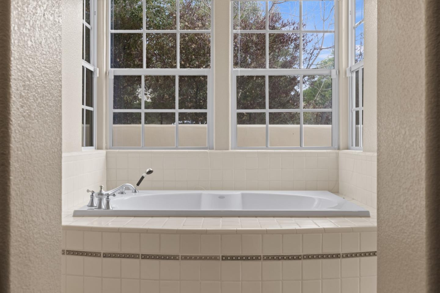 306 Pasadera Drive Monterey, CA 93940 - Photo 36 of 55 a bathroom with bathtub and next to a window