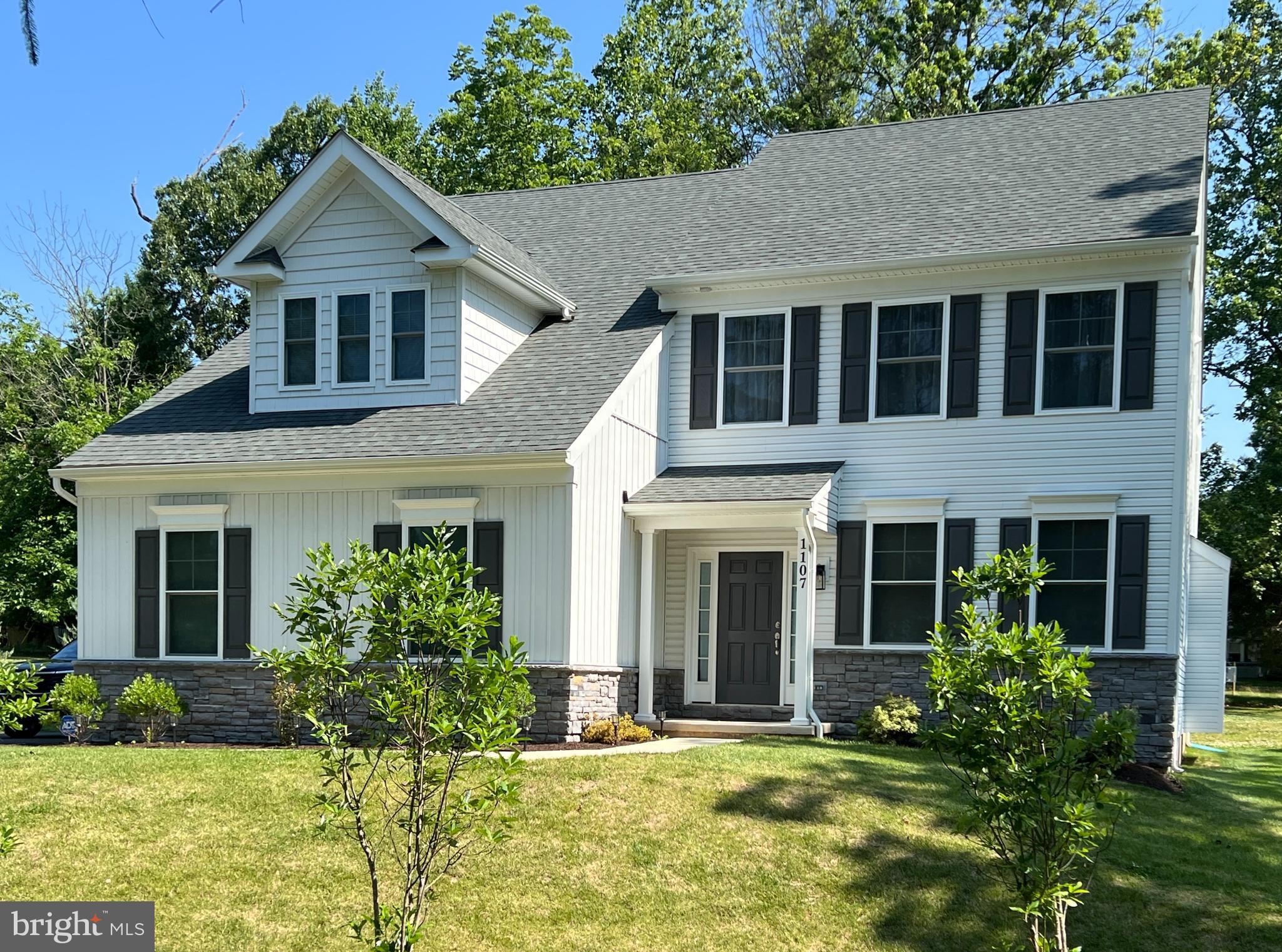 a front view of a house with a yard and porch