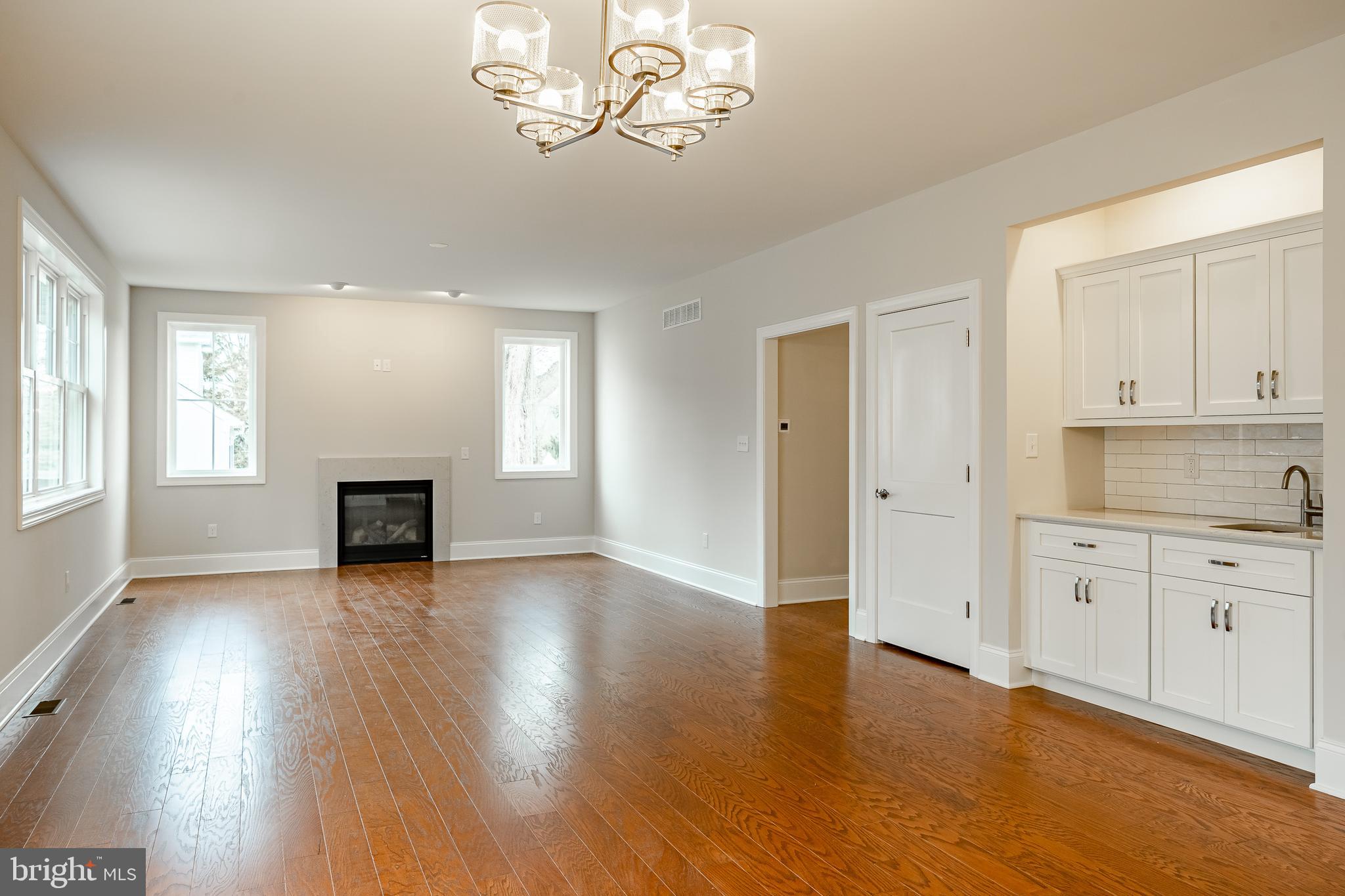 1107 Vilsmeier Road Lansdale, PA 19446 - Photo 27 of 58 an empty room with wooden floor fireplace and windows