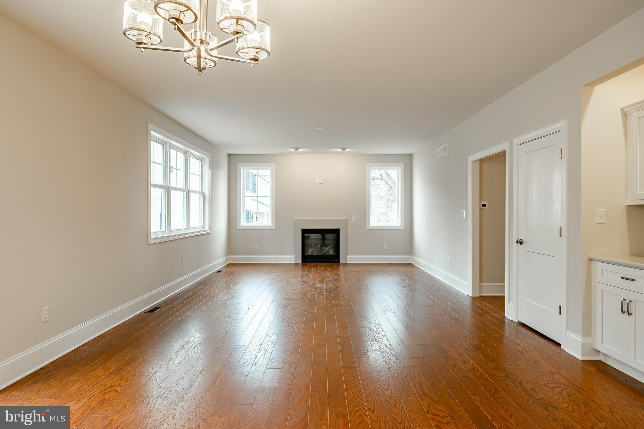 1107 Vilsmeier Road Lansdale, PA 19446 - Photo 28 of 58 an empty room with wooden floor chandelier and windows