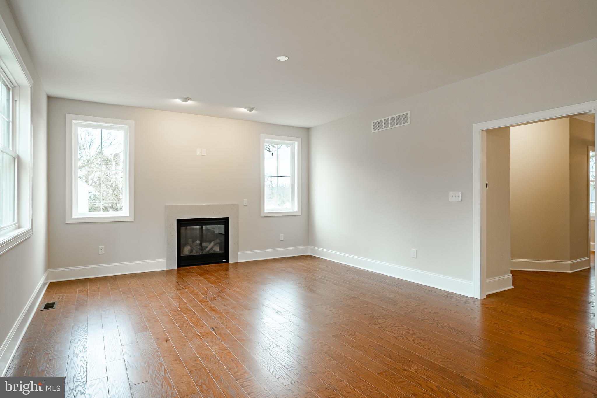 1107 Vilsmeier Road Lansdale, PA 19446 - Photo 29 of 58 an empty room with wooden floor fireplace and windows