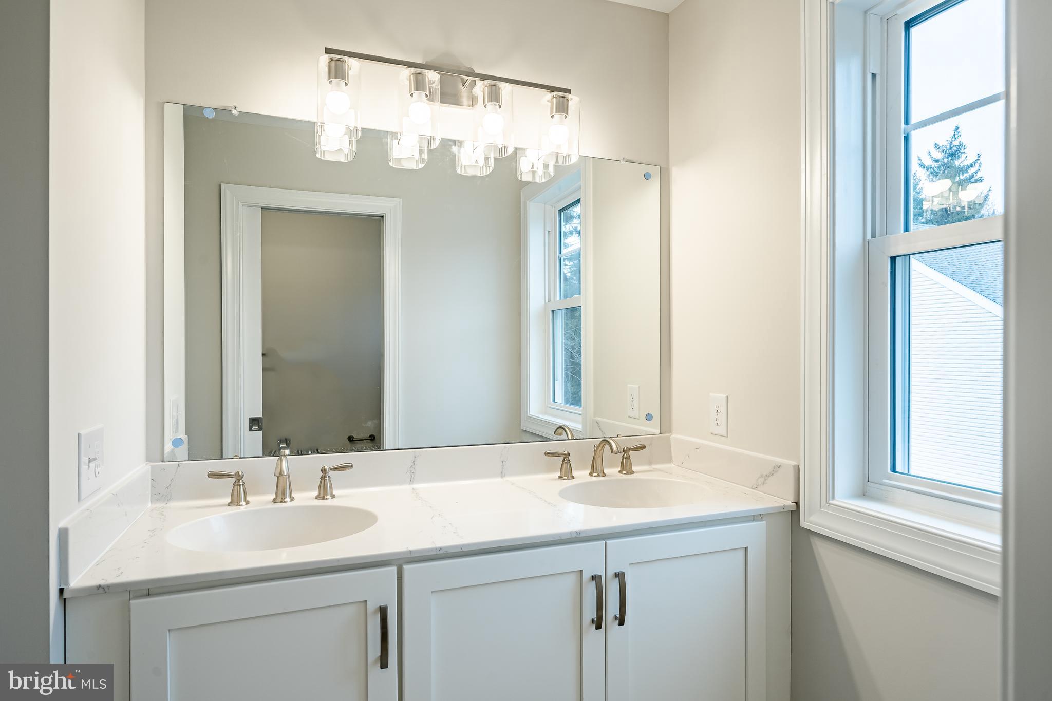 1107 Vilsmeier Road Lansdale, PA 19446 - Photo 35 of 58 a bathroom with a sink double vanity and a mirror