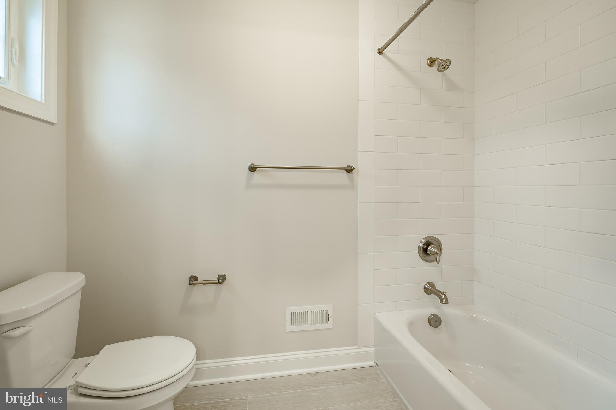 1107 Vilsmeier Road Lansdale, PA 19446 - Photo 36 of 58 a white toilet and tub sitting next to a bathroom sink