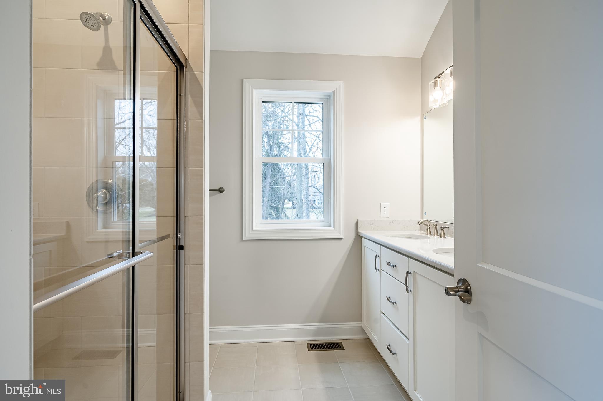 1107 Vilsmeier Road Lansdale, PA 19446 - Photo 46 of 58 a bathroom with a granite countertop sink mirror and a bathtub