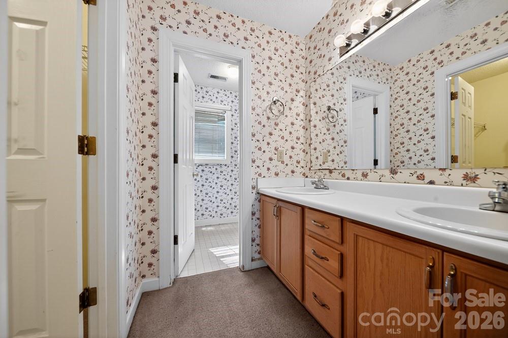 2205 Old Sparta Road Rocky Mount, NC 27804 - Photo 20 of 25 a spacious bathroom with double vanity and a bathtub