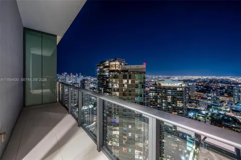 a bedroom with a large bed and a balcony view