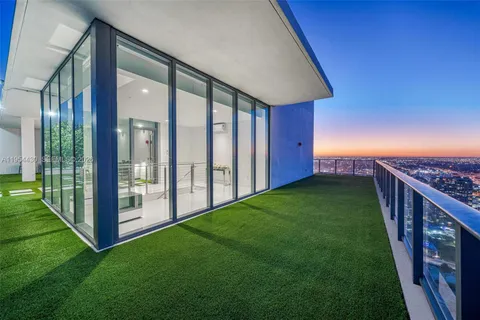 a view of a patio with couches and potted plants with sky view