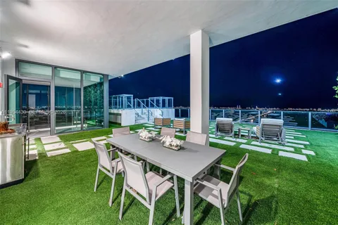 a backyard of a house with outdoor seating