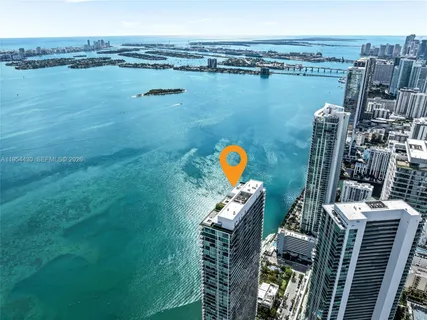 a kitchen with a table chairs stove and kitchen view