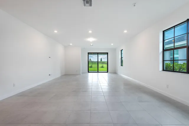 a view of kitchen with a sink and a refrigerator