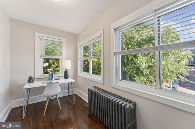 a dining room with wooden floor a glass table and chairs