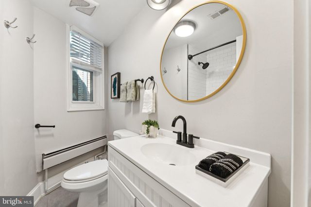 a bathroom with a sink a toilet and a mirror