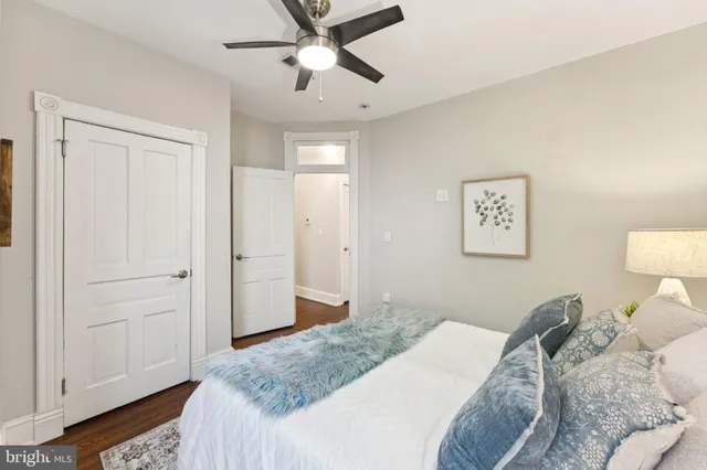 a bedroom with a large bed and a chandelier