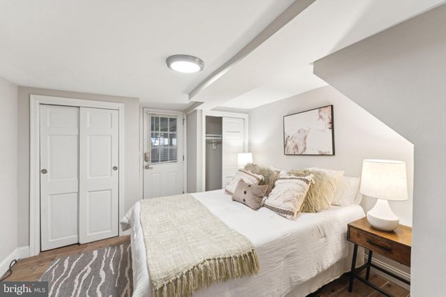 a bedroom with a bed and a painting on the wall