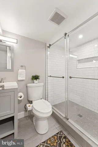 a bathroom with a toilet and a shower