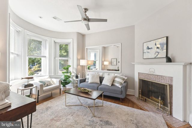 a living room with furniture a window and a fireplace