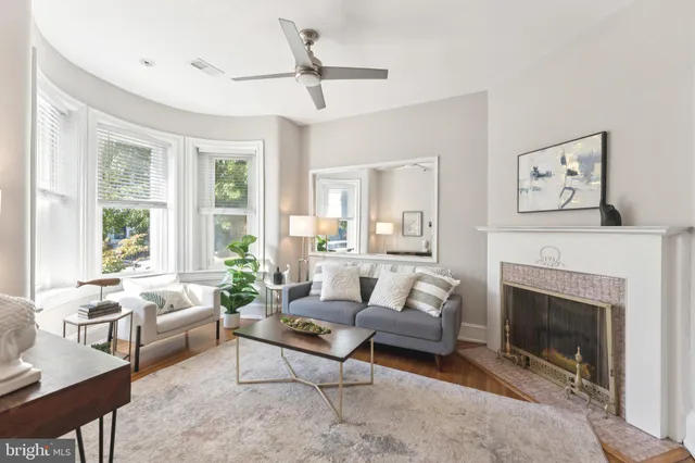 a living room with furniture a window and a fireplace