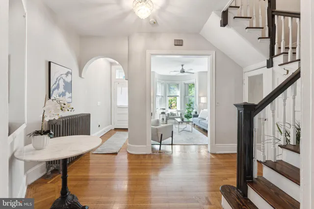a living room with fireplace furniture and a table