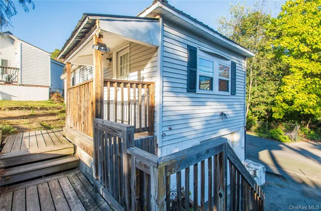 a view of a wooden deck front of house