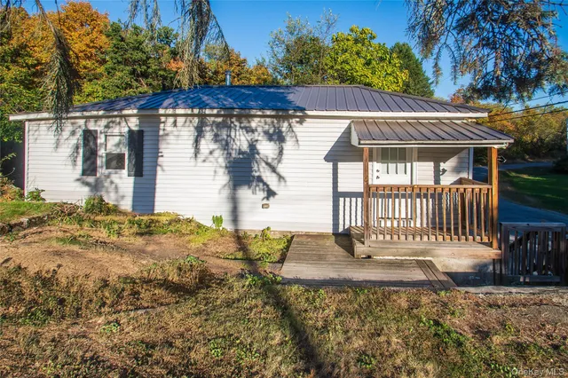 a view of backyard with a patio and wooden fence