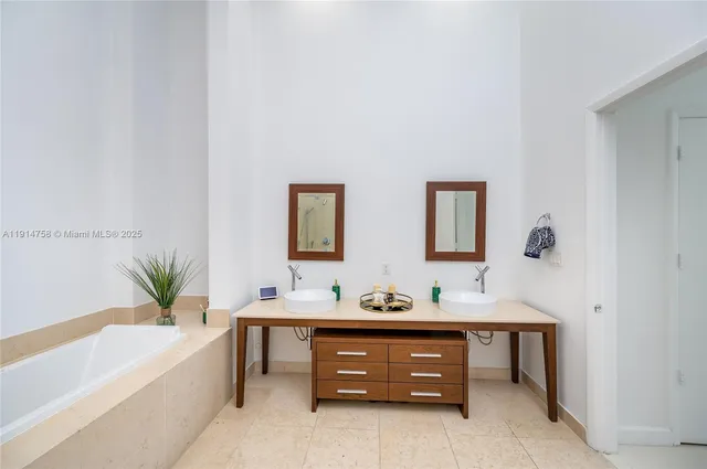 a bathroom with a tub sink and a chair