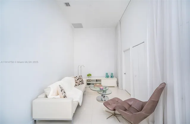 a view of a room with furniture and wooden floor