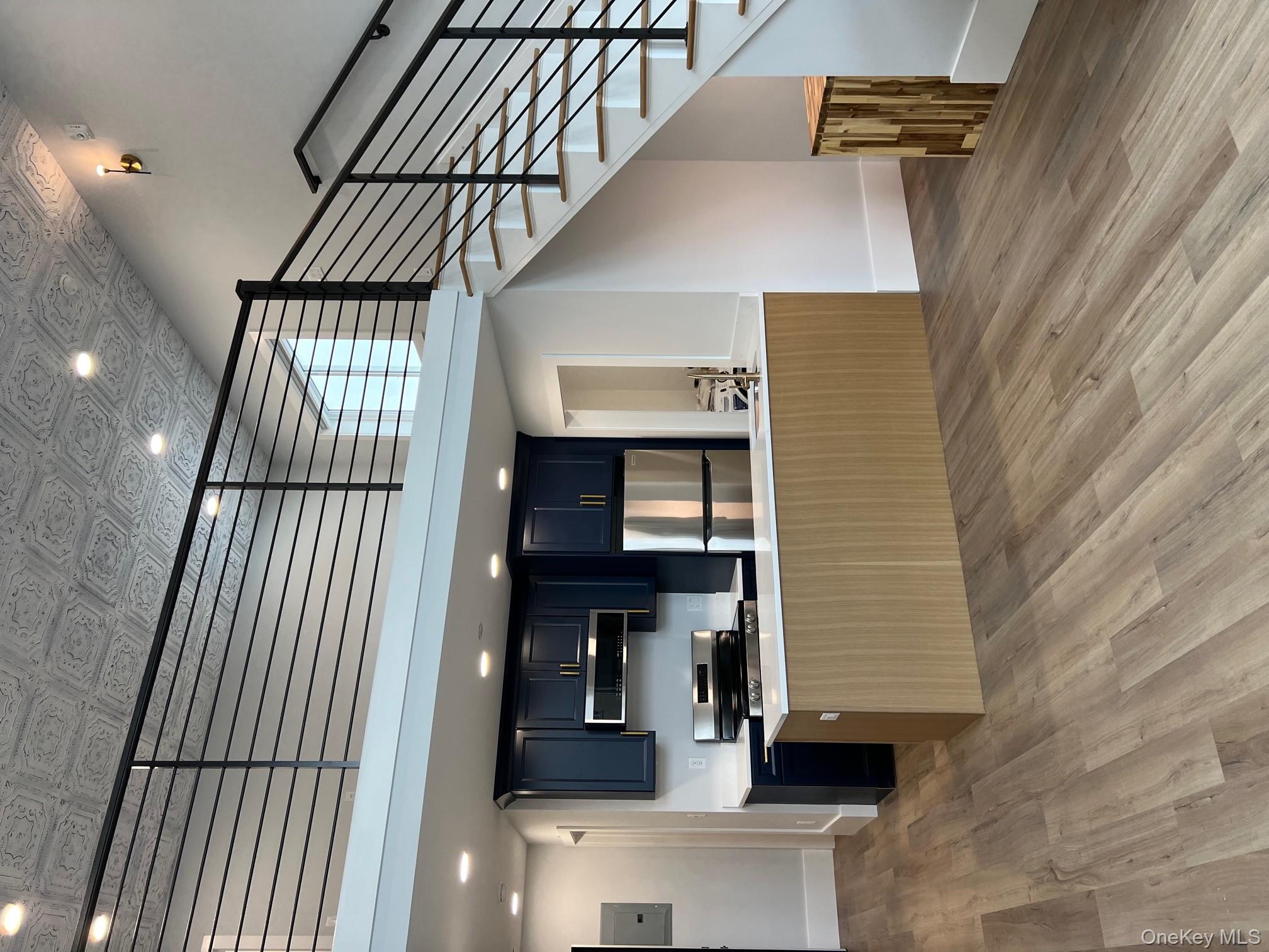 a kitchen with stainless steel appliances granite countertop a stove and a wooden floors