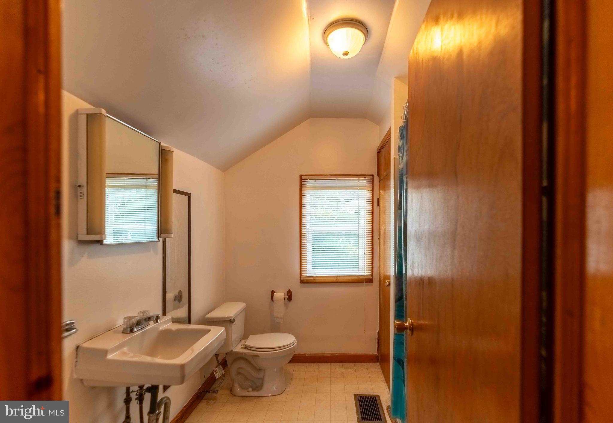 61 Maple Street Cumberland, MD 21502 - Photo 12 of 17 a bathroom with a sink mirror vanity and toilet