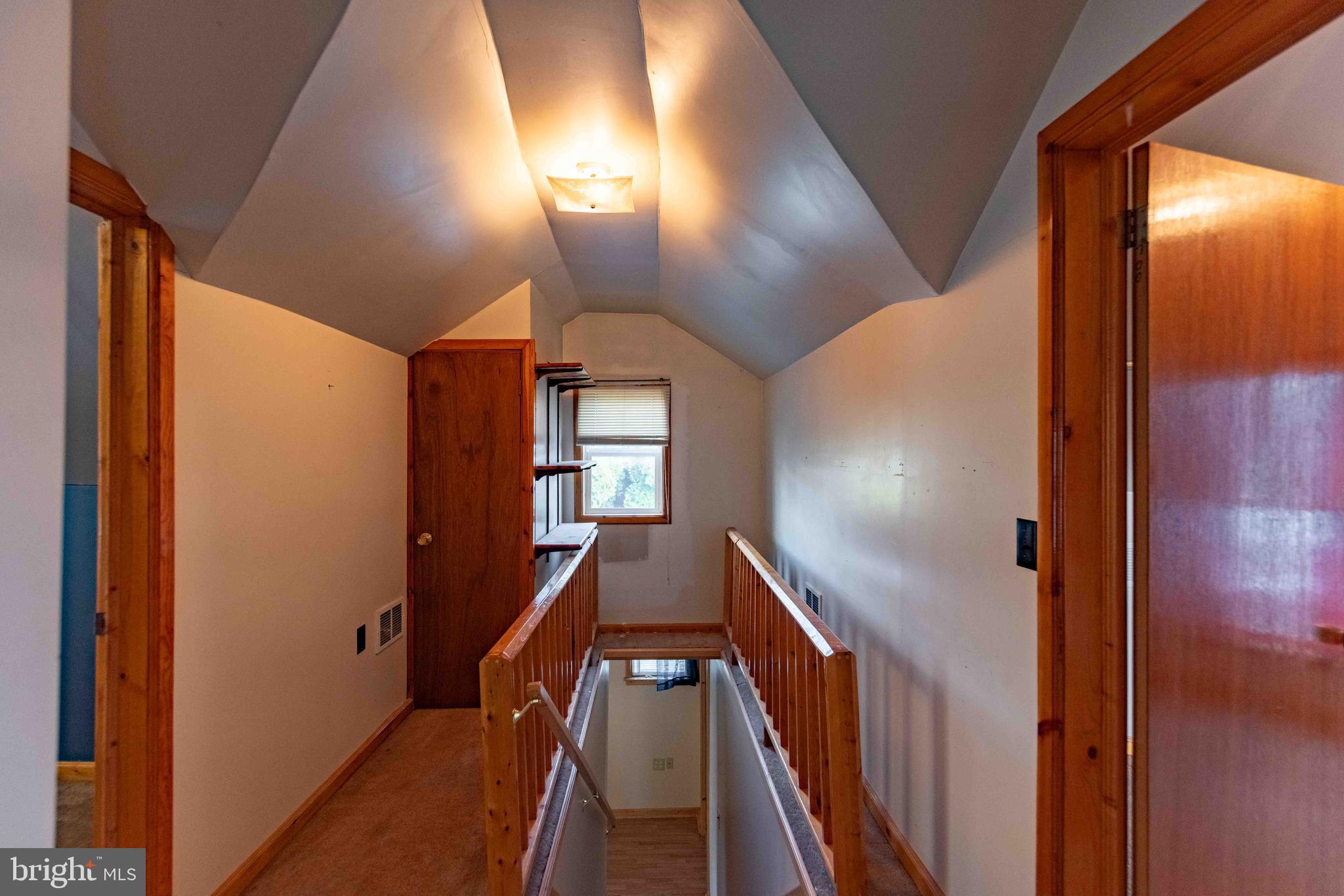 61 Maple Street Cumberland, MD 21502 - Photo 13 of 17 a view of a hallway with wooden floor and staircase