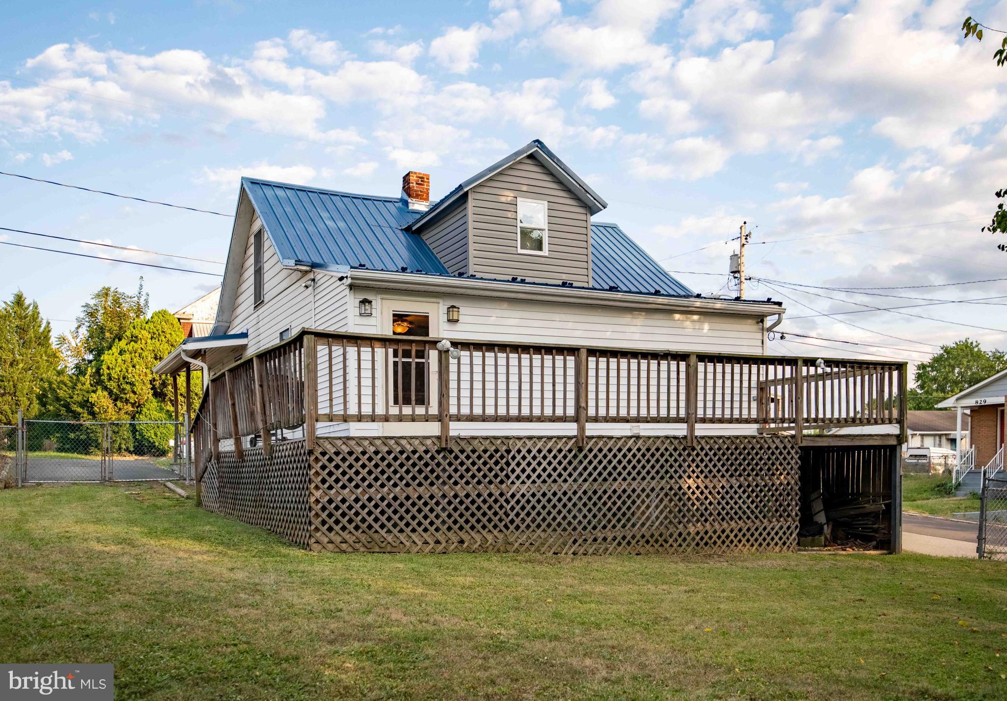 61 Maple Street Cumberland, MD 21502 - Photo 2 of 17 a view of a house with a wooden deck and a yard