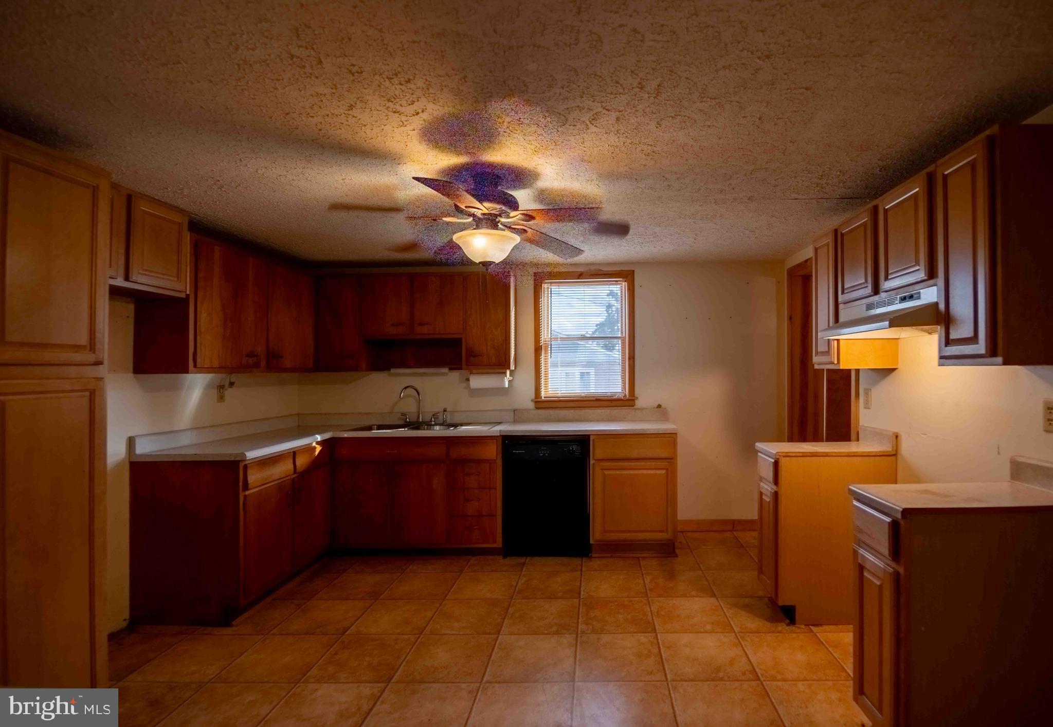 61 Maple Street Cumberland, MD 21502 - Photo 5 of 17 a kitchen with stainless steel appliances granite countertop a sink counter space cabinets and a stove