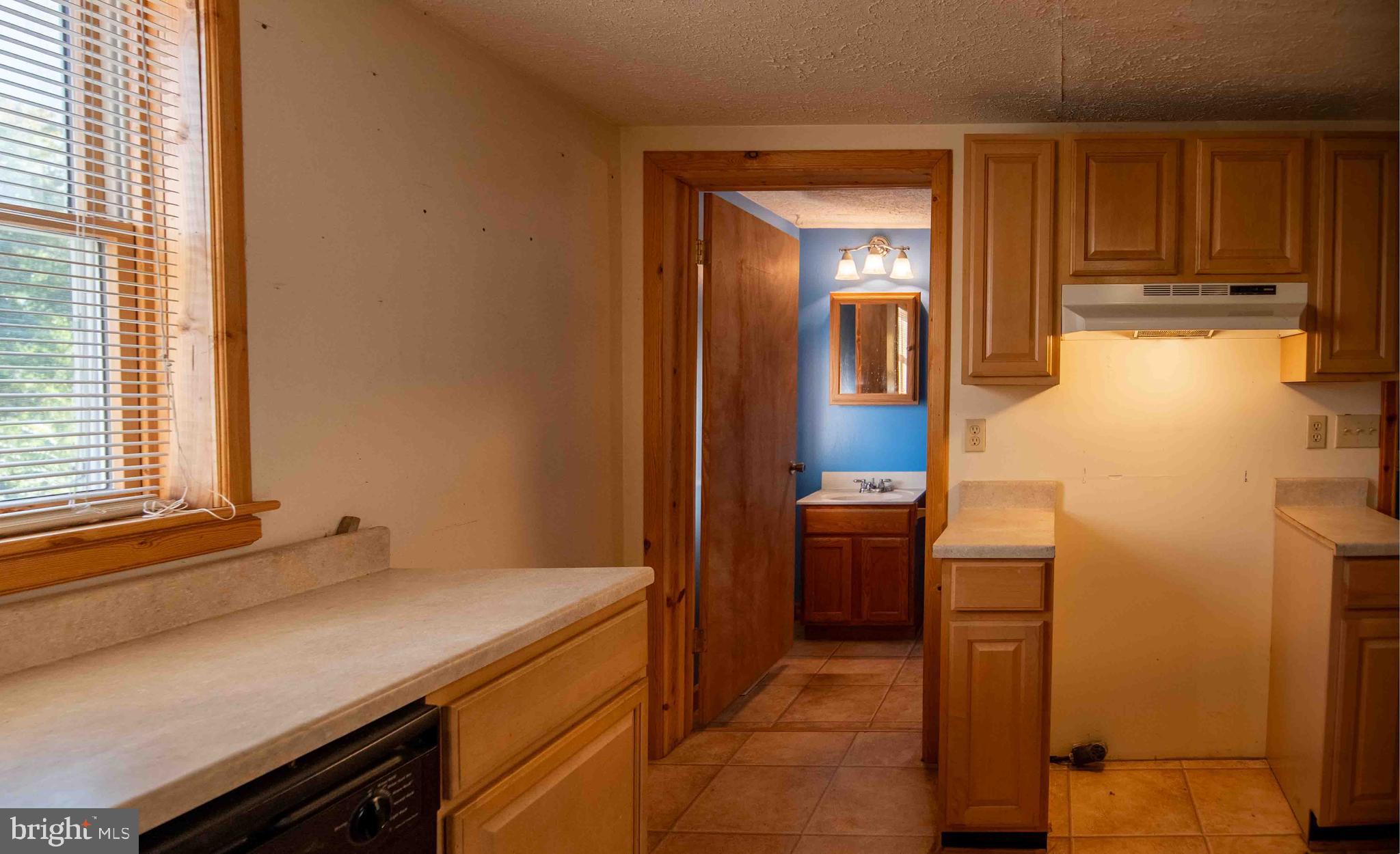 61 Maple Street Cumberland, MD 21502 - Photo 6 of 17 a kitchen with a refrigerator and a stove