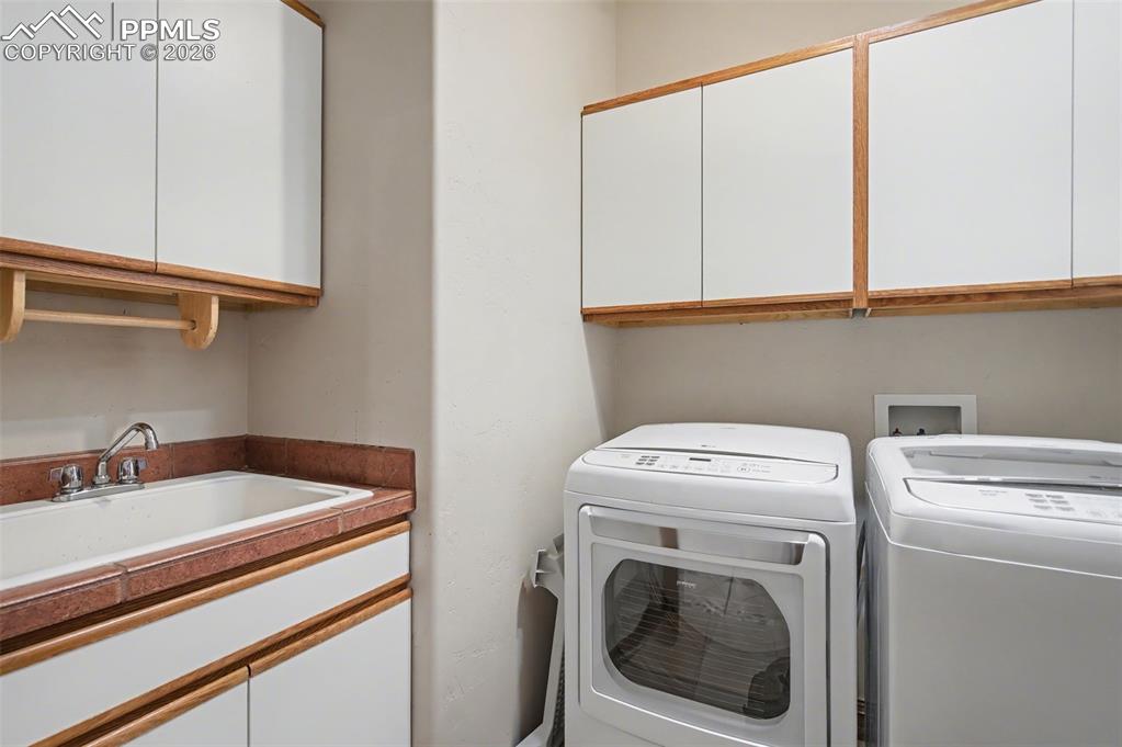 4215 Star Ranch Road Colorado Springs, CO 80906 - Photo 25 of 44 a utility room with dryer and washer