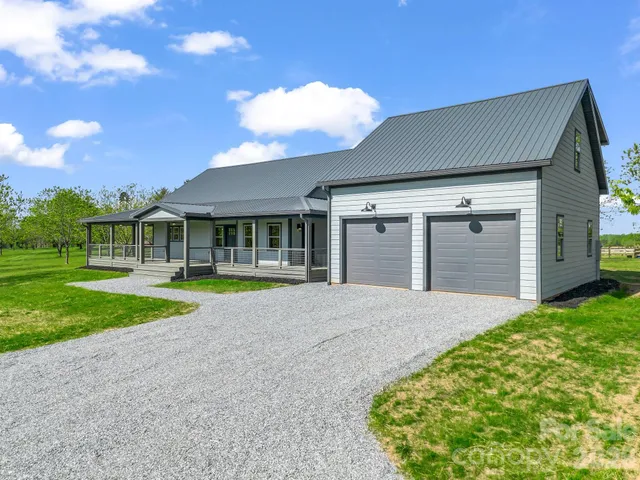 a view of an house with backyard space and balcony