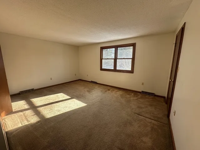 an empty room with closet area