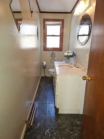 a bathroom with sink a mirror and toilet