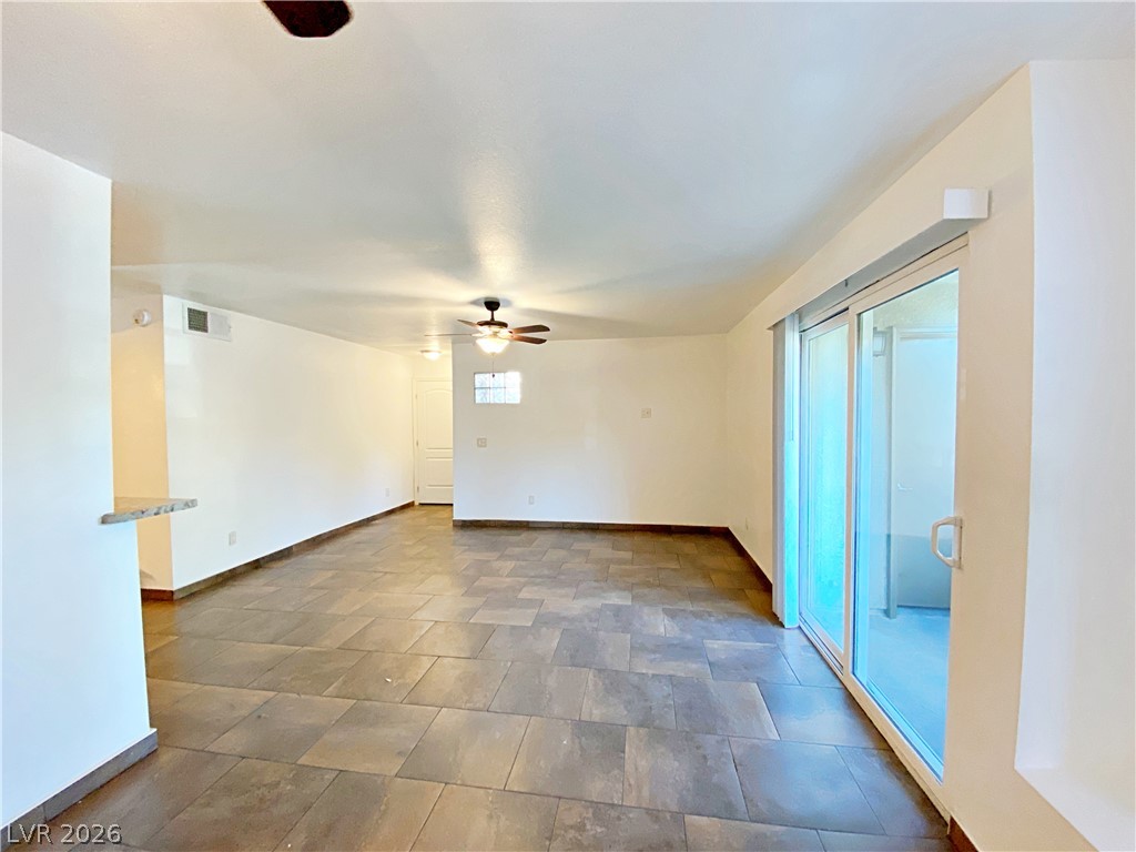3145 East Flamingo Road, Unit 1128 Las Vegas, NV 89121 - Photo 5 of 19 A spacious living area features cool tile flooring and direct access to outdoor leisure.