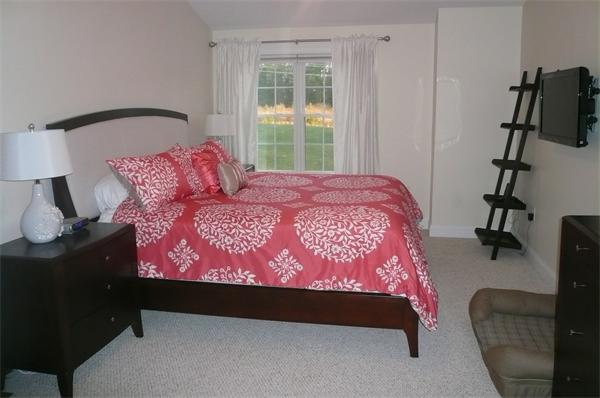 7 C Charles Ridge Road, Unit C Littleton, MA 01460 - Photo 12 of 18 a bed sitting in a bedroom next to a window