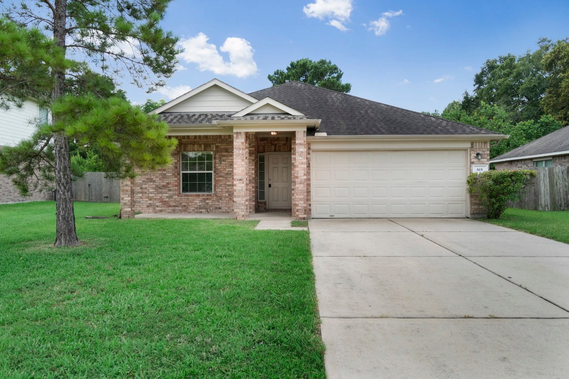 Welcome home to this charming brick residence, featuring a spacious driveway, lush green lawn, and quiet cul-de-sac
